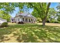 Beautiful single Gathering home featuring a large front yard and a covered front porch with stone pillars at 4960 York Hwy, Rock Hill, SC 29732