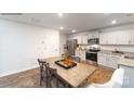 Charming eat-in kitchen features stainless appliances, granite counters, and a wood dining table at 581 E Sparkleberry St, Chester, SC 29706