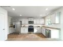 Bright kitchen with stainless steel appliances, granite countertops, and white cabinets at 581 E Sparkleberry St, Chester, SC 29706