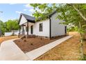 Stylish single-story home showcasing a sidewalk, black accents, and white siding at 605 Stirewalt Rd, China Grove, NC 28023