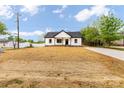Charming single-story home features black trim, a dark roof and a driveway at 605 Stirewalt Rd, China Grove, NC 28023