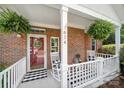 Inviting front porch with white railings, rocking chairs, and a decorative wreath at 614 Stone Village Dr, Fort Mill, SC 29708