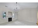 Cozy living room with fireplace, white walls and trim, and large windows at 614 Stone Village Dr, Fort Mill, SC 29708