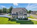 Beautiful two-story home with well-maintained lawn, white picket fence and inviting front porch at 6314 Bluffton Ln, Midland, NC 28107