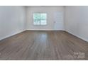 Bright and spacious living room with wood flooring and natural light from a large window at 6717 Ware Rd, Charlotte, NC 28212