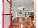 Spacious open-concept living room with gleaming hardwood floors at 7020 Cedar Ridge Ct, Mount Holly, NC 28120