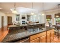 Open kitchen featuring granite countertops, stainless steel appliances, and a view of the living area at 7245 Willow Brook Ct, Denver, NC 28037
