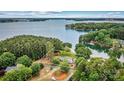 Lakefront home with lush trees, private access to the water, and mature landscaping throughout the property at 8218 Bright Water Ln, Denver, NC 28037