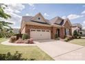 Elegant brick home showcases a well-maintained lawn, complemented by a convenient two-car garage at 9026 Raven Top Dr, Mint Hill, NC 28227