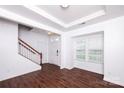 Bright entryway with hardwood floors, staircase, and natural light from the front window at 9614 Springholm Dr, Charlotte, NC 28278