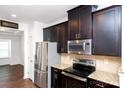 Modern kitchen with granite countertops, stainless steel appliances, and dark cabinetry at 9614 Springholm Dr, Charlotte, NC 28278