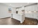 Bright kitchen with white cabinets, a large island, and stainless steel appliances at 9944 Manor Vista Trl, Kannapolis, NC 28027