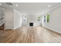 Spacious living room featuring wood-look floors, fireplace, and windows with natural light and recessed lighting at 9956 Manor Vista Trl, Kannapolis, NC 28027