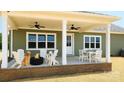 Inviting covered back porch with ceiling fans, fire pit, and outdoor seating; perfect for entertaining at Lot 101 Coppergate Dr, Salisbury, NC 28147