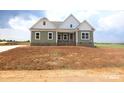 New construction with a mix of brick and siding on a spacious lot awaiting landscaping at Lot 101 Coppergate Dr, Salisbury, NC 28147