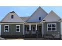 Charming new construction home featuring a welcoming covered front porch at Lot 101 Coppergate Dr, Salisbury, NC 28147