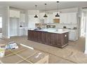 Spacious kitchen featuring white cabinets, a large island, and modern pendant lighting at Lot 101 Coppergate Dr, Salisbury, NC 28147
