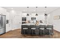 Modern kitchen featuring a large island with seating, white cabinets, and stainless steel appliances at Lot 101 Coppergate Dr, Salisbury, NC 28147