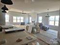 Bright and airy living room with tray ceilings, a ceiling fan, and multiple windows at Lot 101 Coppergate Dr, Salisbury, NC 28147