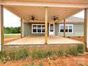 Covered patio with exposed wooden beams and dual ceiling fans; perfect for outdoor enjoyment at Lot 101 Coppergate Dr, Salisbury, NC 28147