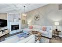 Cozy living room featuring a brick fireplace, comfortable seating, and stylish decor accents at 10016 Tealridge Ln, Charlotte, NC 28277