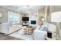 Inviting living room with a brick fireplace, ample natural light, comfortable seating, and stylish accents at 10016 Tealridge Ln, Charlotte, NC 28277