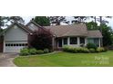 Charming single-story home featuring well-maintained landscaping and attached two-car garage at 104 Gallarie Pl, Salisbury, NC 28144