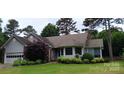 Charming single-story home featuring well-maintained landscaping and attached two-car garage at 104 Gallarie Pl, Salisbury, NC 28144