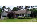 Charming single-story home featuring well-maintained landscaping and attached two-car garage at 104 Gallarie Pl, Salisbury, NC 28144