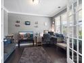 Comfortable home office with gray walls, hardwood floors, large desk, and ample light at 1305 Kings Grove Dr, York, SC 29745