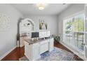Bright home office featuring a large window, built-in shelving, and a stylish desk area at 16831 Alydar Commons Ln, Charlotte, NC 28278