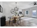 Bright dining area featuring modern light fixture, decorative clock and wall art and white trim and walls at 177 Briana Marie Way, Indian Trail, NC 28079