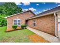 A welcoming brick home showcasing manicured bushes and an inviting walkway to the front door at 1866 Charter Dr, Rock Hill, SC 29732