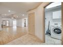 Open living area with laminate flooring, leading to the laundry room and featuring a vaulted ceiling at 1866 Charter Dr, Rock Hill, SC 29732