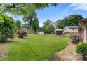 Spacious backyard with a mix of green lawn, mature trees, and privacy fence at 1940 12Th Ne St, Hickory, NC 28601