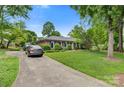 Well-maintained brick home with a long driveway and lush green lawn at 1940 12Th Ne St, Hickory, NC 28601
