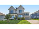 Charming two-story home featuring stone accents, gray siding, and a well-manicured lawn with a concrete driveway at 2322 Tessa Trce, Clover, SC 29710