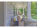Cozy porch featuring stone accents, comfortable seating, and a relaxing spot at 2902 Oakdale Rd, Charlotte, NC 28216