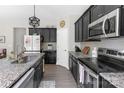 Well-equipped kitchen featuring black cabinets, granite countertops, and stainless steel appliances at 2902 Oakdale Rd, Charlotte, NC 28216