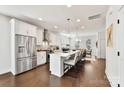 Open kitchen features stainless steel appliances, a large island with seating, and bright white cabinets at 330 Armour St # 46, Davidson, NC 28036