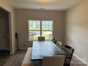 Bright dining area features a large window and a rustic wood table with bench seating at 348 Ox Bow Cir, Mount Holly, NC 28120