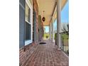 Covered front porch featuring brick flooring and column supports at 3660 9Th Street Ne Dr, Hickory, NC 28601