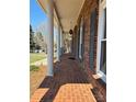Inviting covered front porch with brick flooring and classic columns at 3660 9Th Street Ne Dr, Hickory, NC 28601