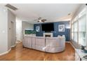 Open-concept living room with hardwood floors, fireplace, and large sectional sofa at 3915 Planters Watch Dr, Charlotte, NC 28278
