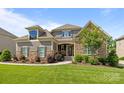 Beautiful home with a well-kept lawn and landscaped garden beds adding to the curb appeal at 6008 Candlestick Ln, Lancaster, SC 29720