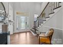 Bright foyer featuring a staircase, hardwood floors, and a glass front door for natural light at 6008 Candlestick Ln, Lancaster, SC 29720