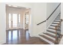 Elegant foyer with gleaming hardwood floors, staircase, and double glass doors at 809 Brown Creek Dr, Matthews, NC 28104