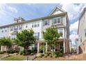 Attractive three-story townhome featuring stone accents, neutral siding, and well-maintained landscaping at 9521 Ainslie Downs St, Charlotte, NC 28273