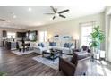 Open-concept living space featuring hardwood floors, modern decor, and a seamless flow to the dining area and kitchen at 9521 Ainslie Downs St, Charlotte, NC 28273