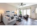 Inviting living room with ample natural light, stylish furnishings, and a ceiling fan, creating a cozy and airy atmosphere at 9521 Ainslie Downs St, Charlotte, NC 28273